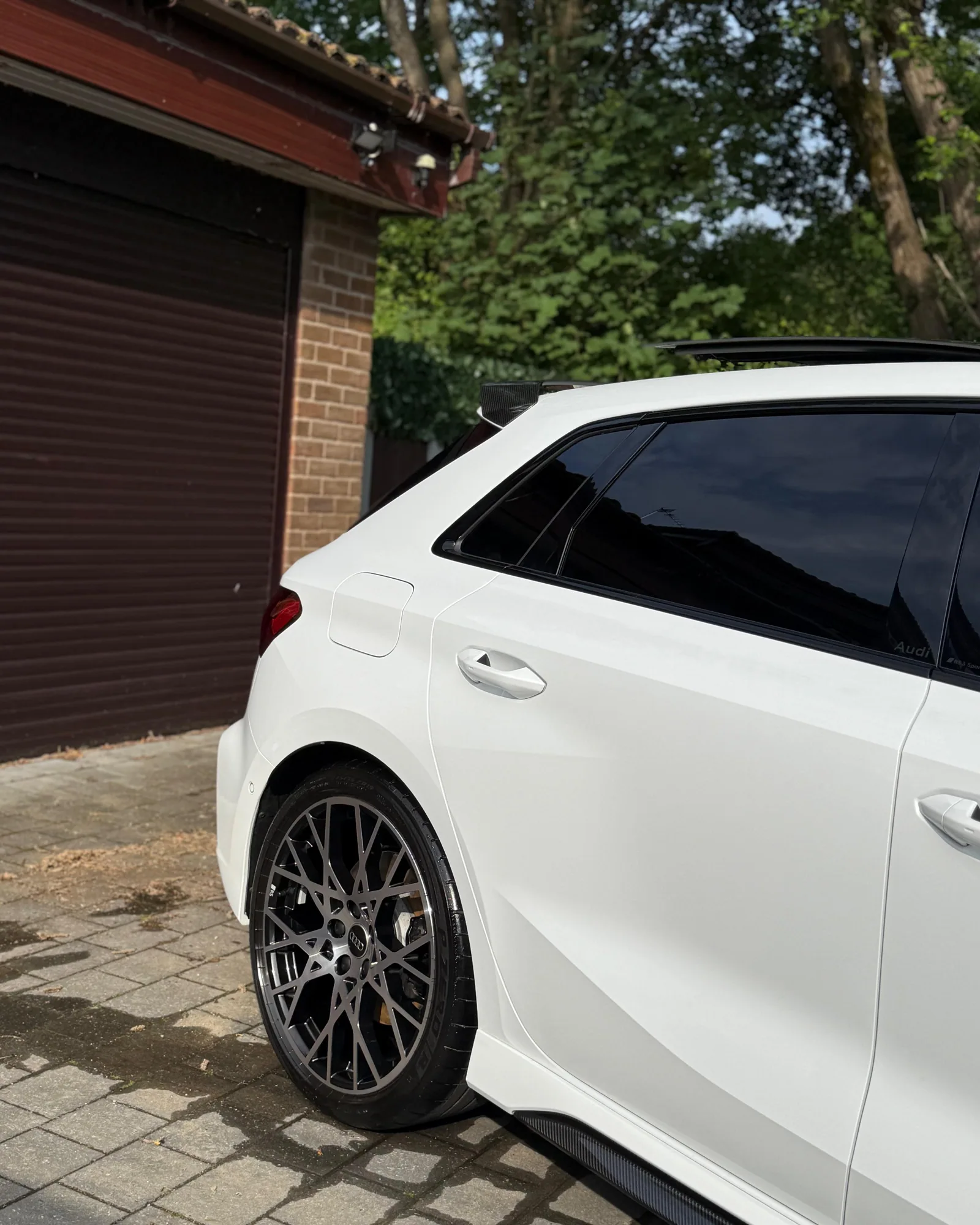 White Audi RS 3 rear side panel and wheel after detailing