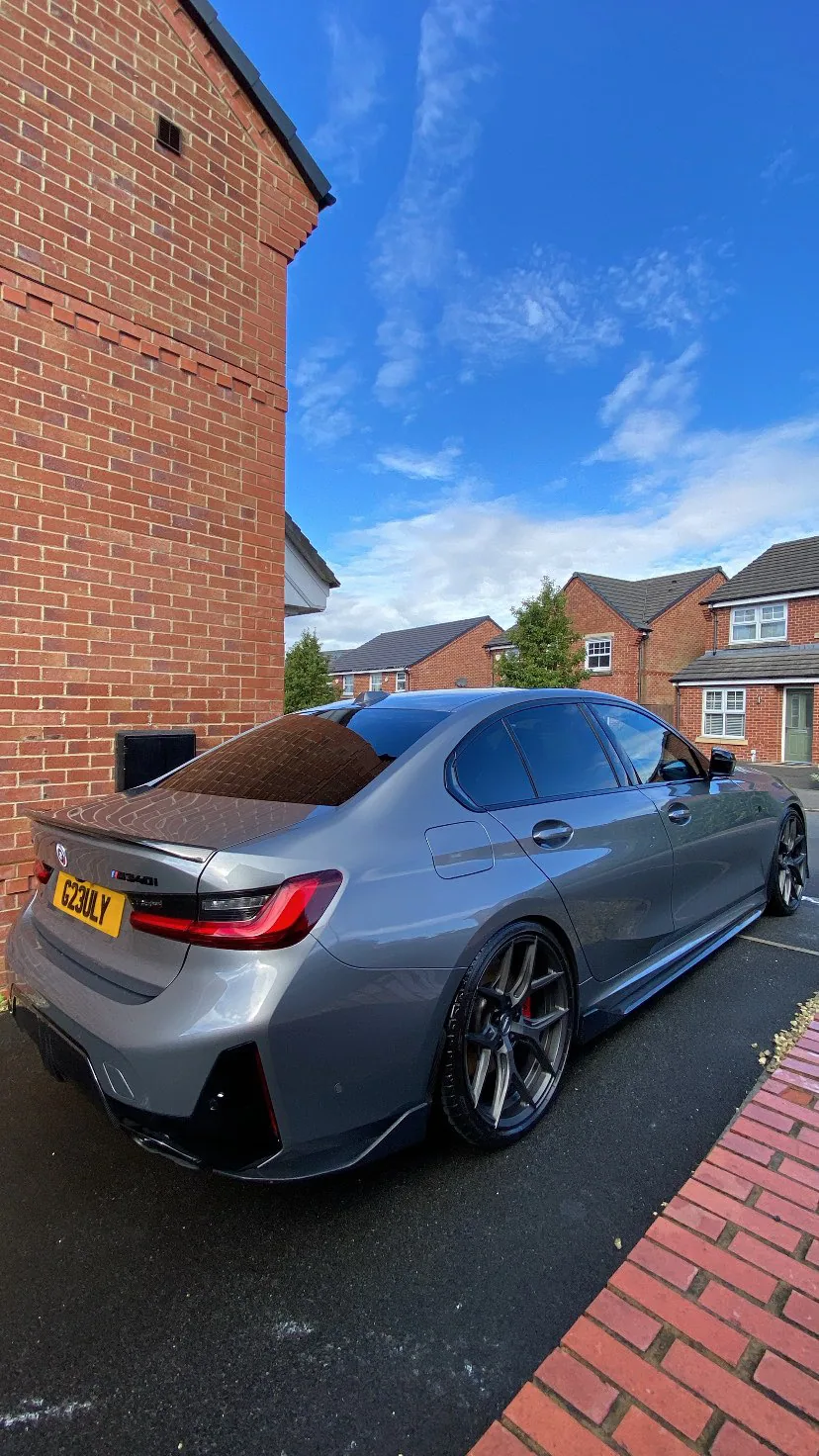 Grey BMW M340i rear quarter and side reflection after detailing