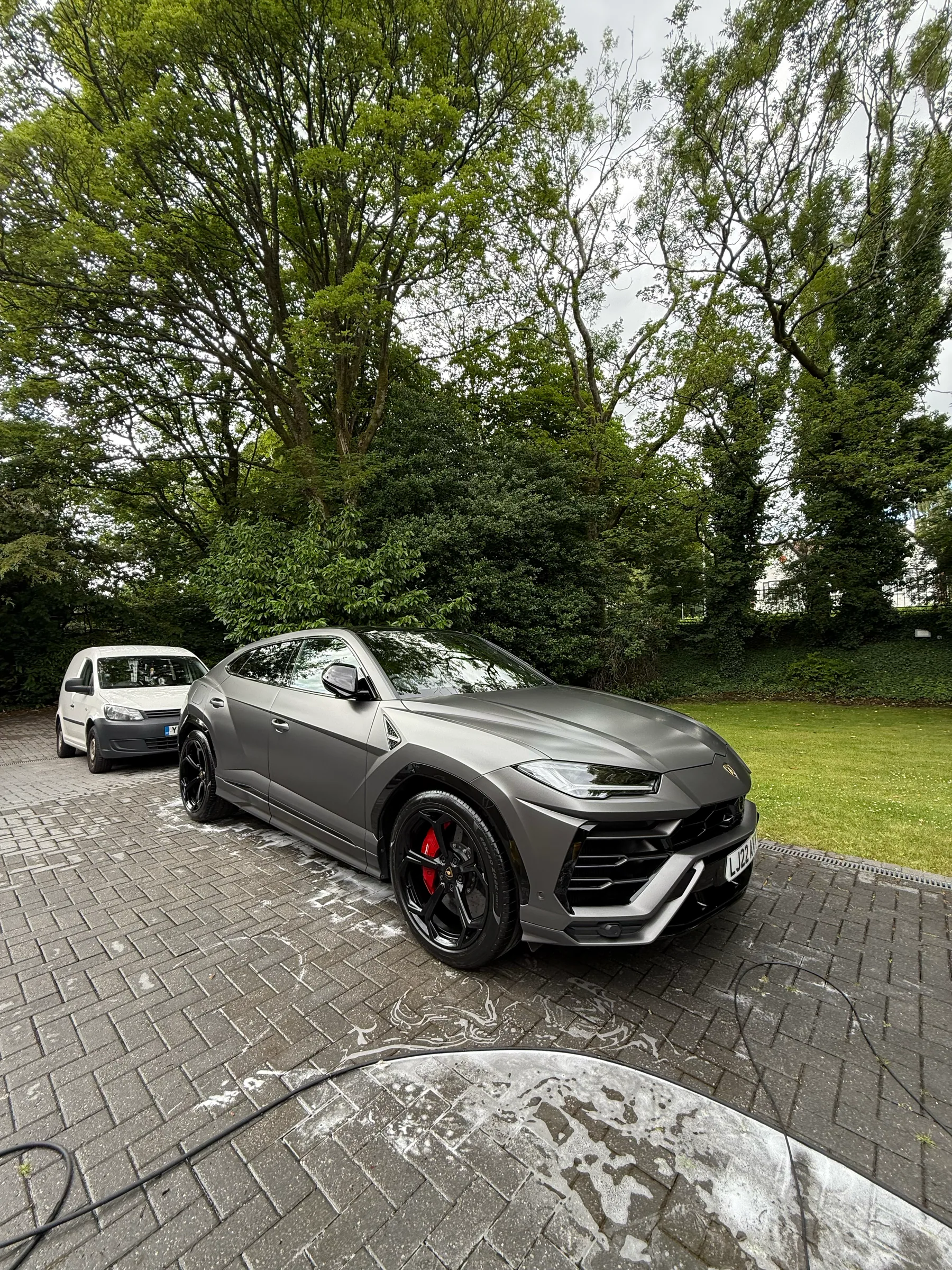 Black Lamborghini Urus front three-quarter view after detailing