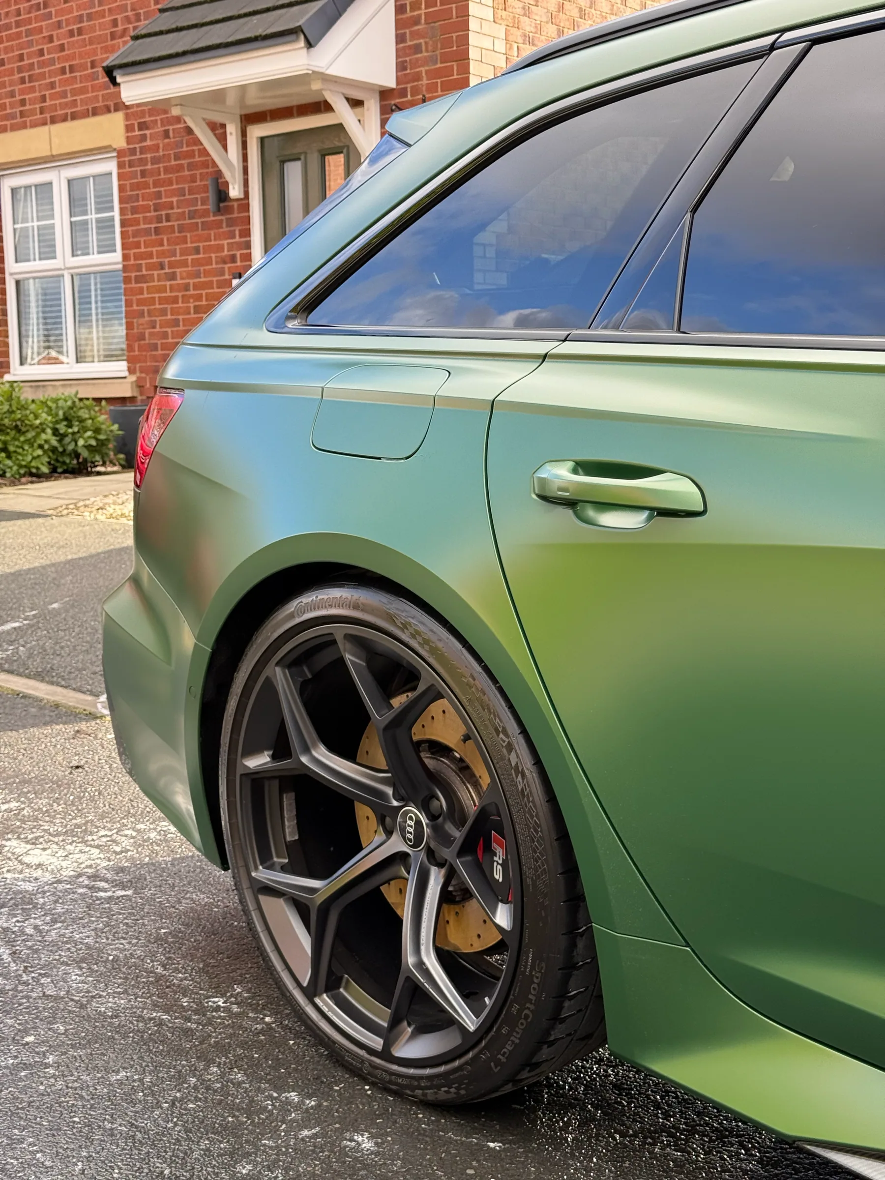 Green Audi Avant rear quarter, glass and wheel finish after detailing