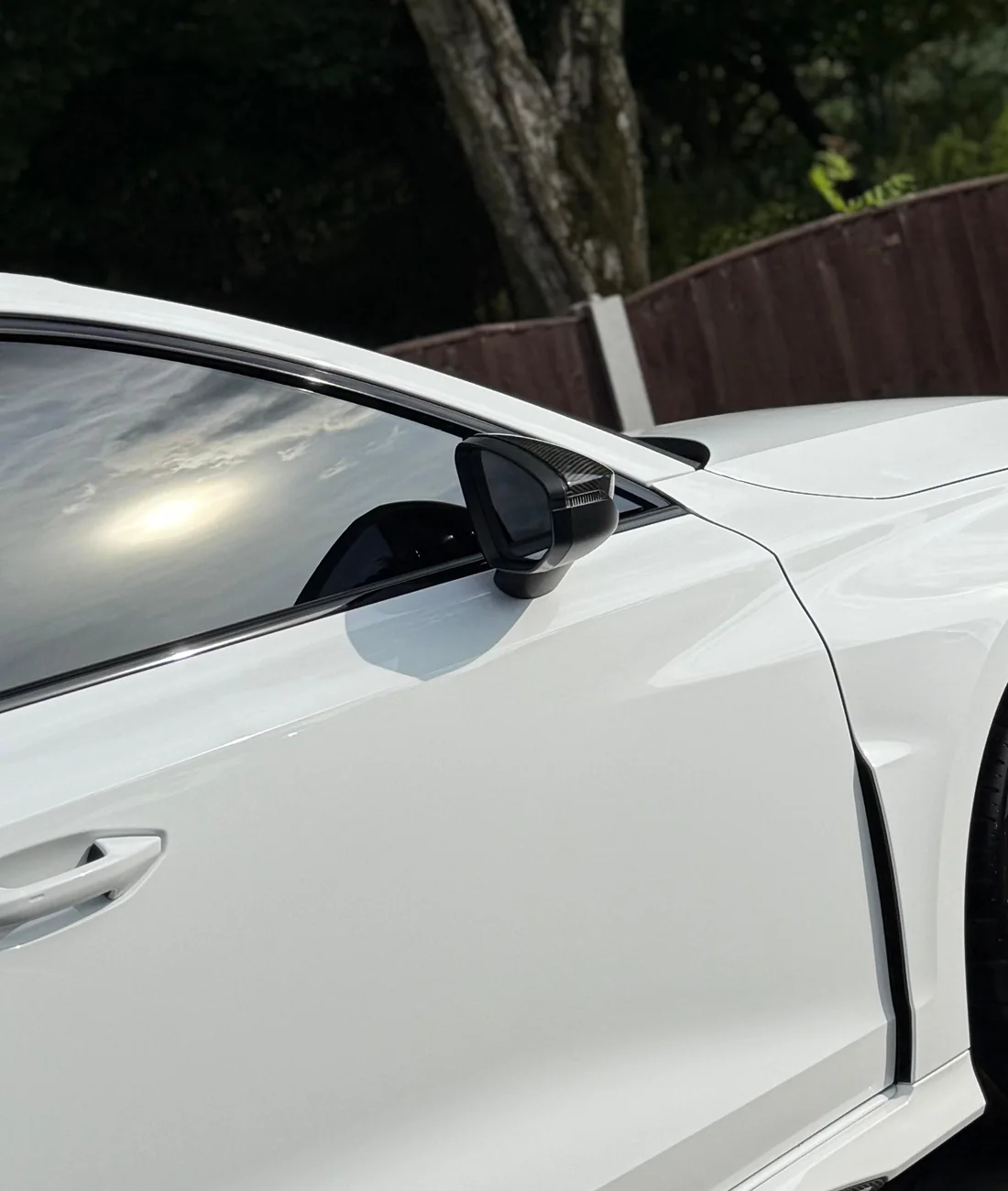 White Audi RS 3 side panel and mirror reflection after detailing